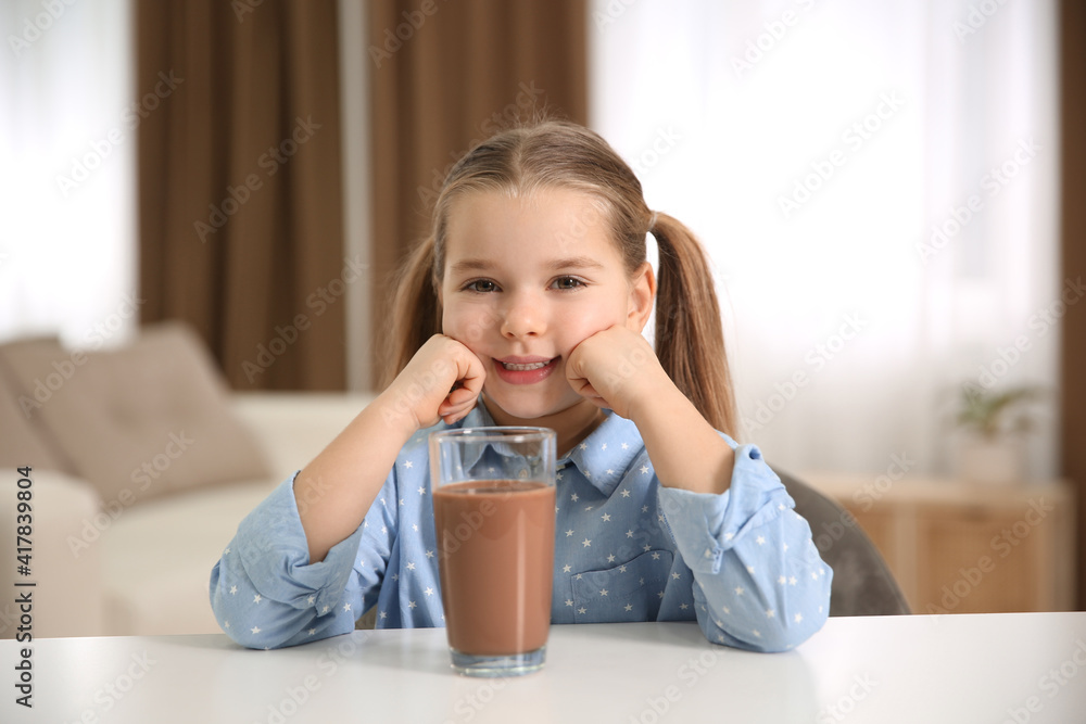 Cute little child with glass of tasty chocolate milk at home Cute little child with glass of tasty chocolate milk at home