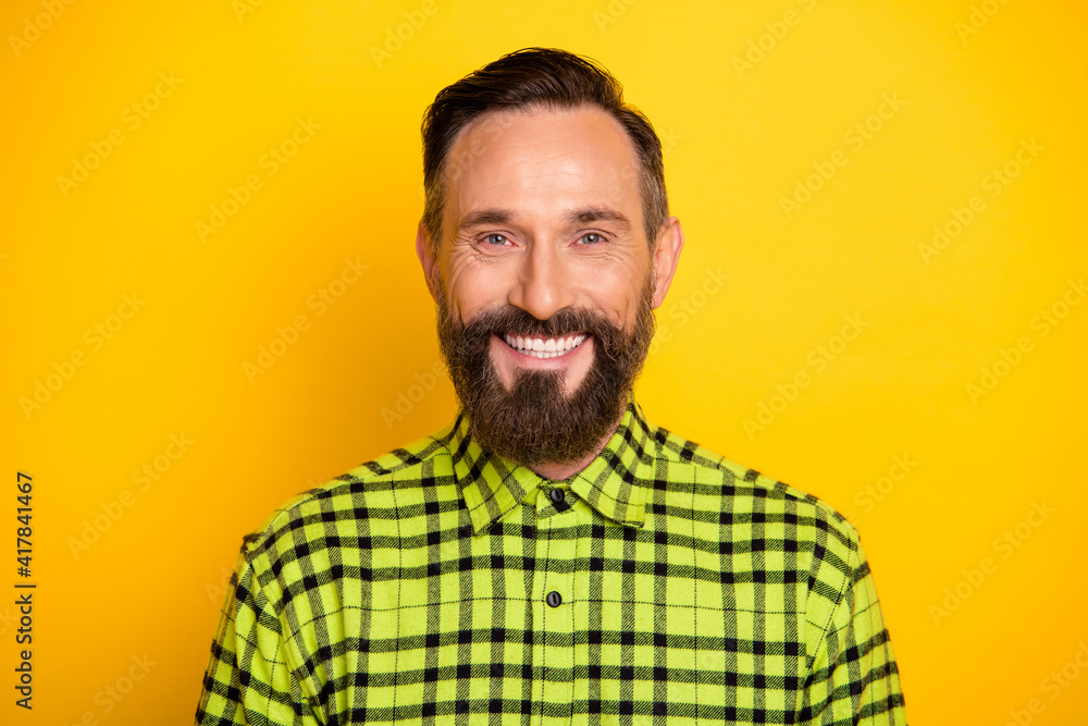 Obraz premium Photo of young cheerful mature man happy positive smile wear casual shirt isolated over yellow color background