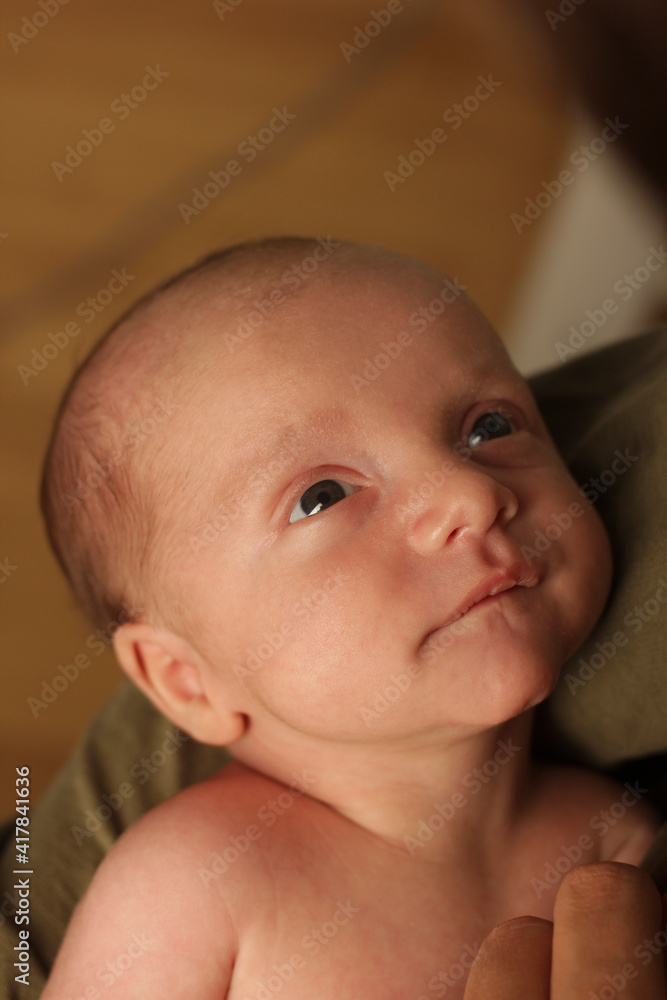 tender look of a newborn baby to his father tender look of a newborn baby to his father