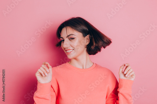 Funny young woman 20s in casual clothes isolated on pink background studio portrait. People emotions lifestyle concept. Mock up copy space. Shaking head with flowing hair