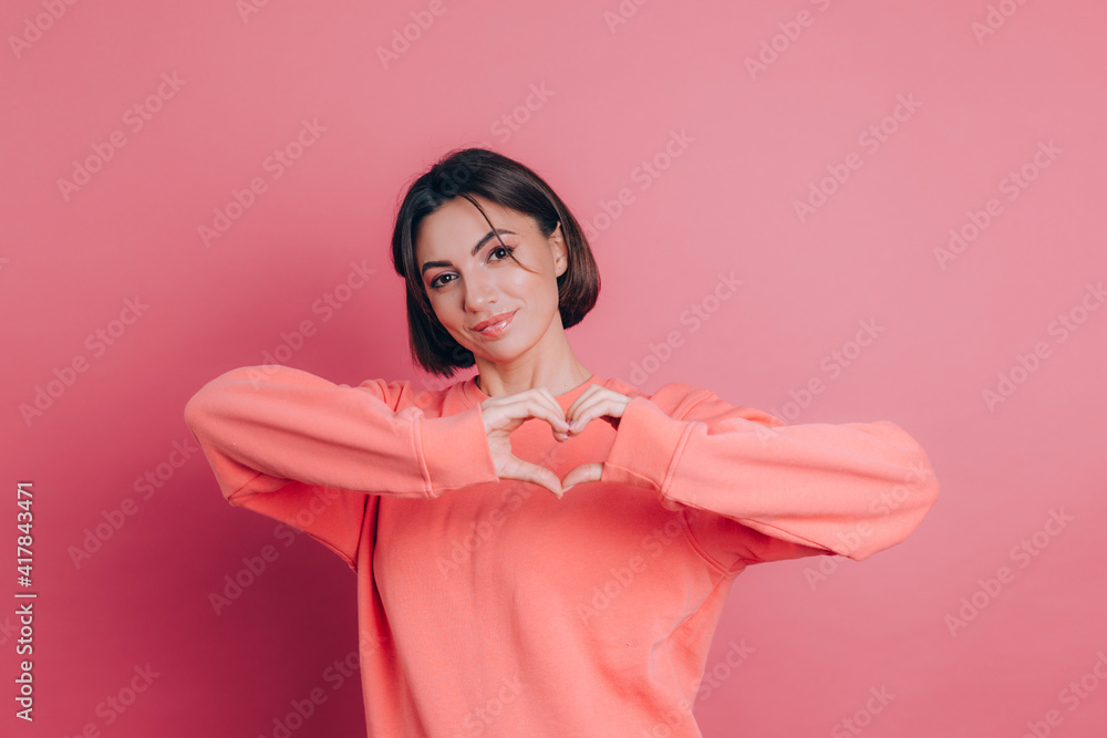 Funny young woman 20s in casual clothes isolated on pink background studio portrait. Love concept. Mock up copy space. Shows heart with hands. Funny young woman 20s in casual clothes isolated on pink background studio portrait. Love concept. Mock up copy space. Shows heart with hands.
