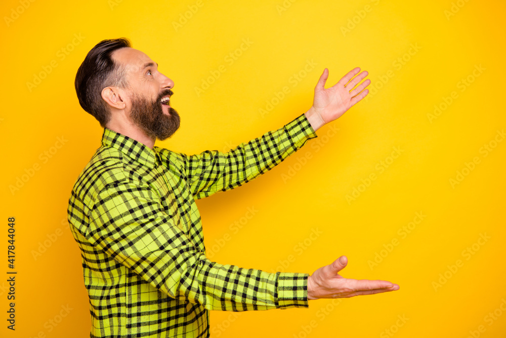 Profile side view portrait of attractive cheerful man welcoming dream copy space isolated over bright yellow color background