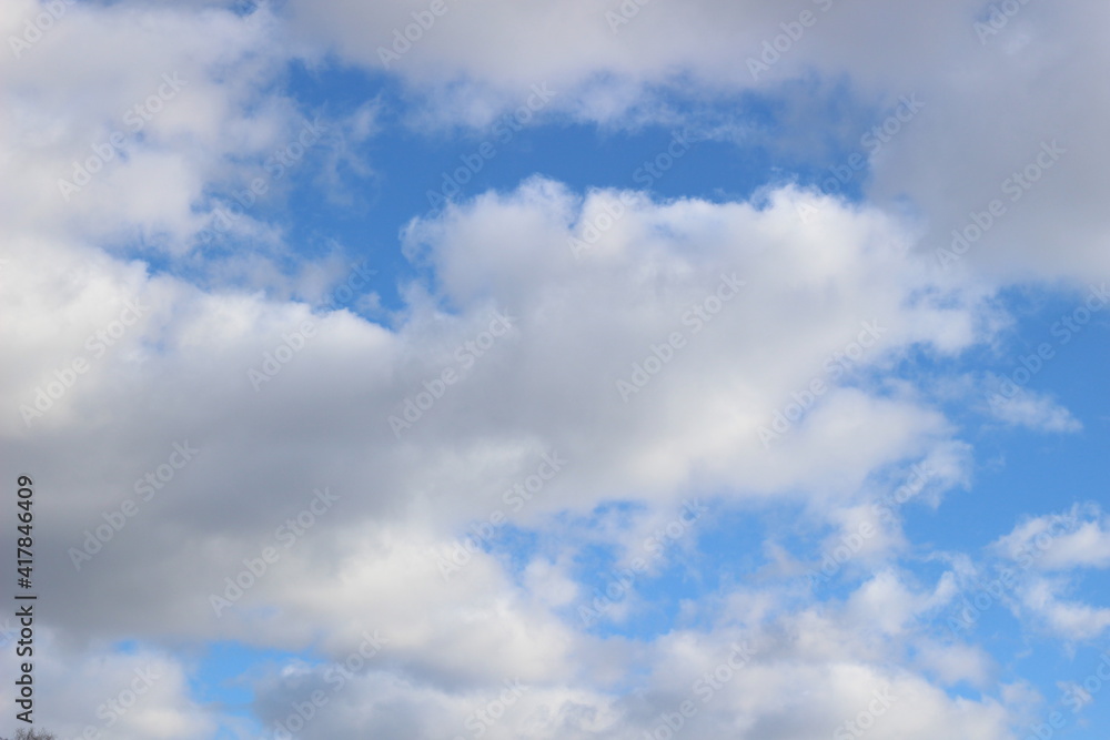 Bright spring blue sky with white clouds in sun light Bright spring blue sky with white clouds in sun light
