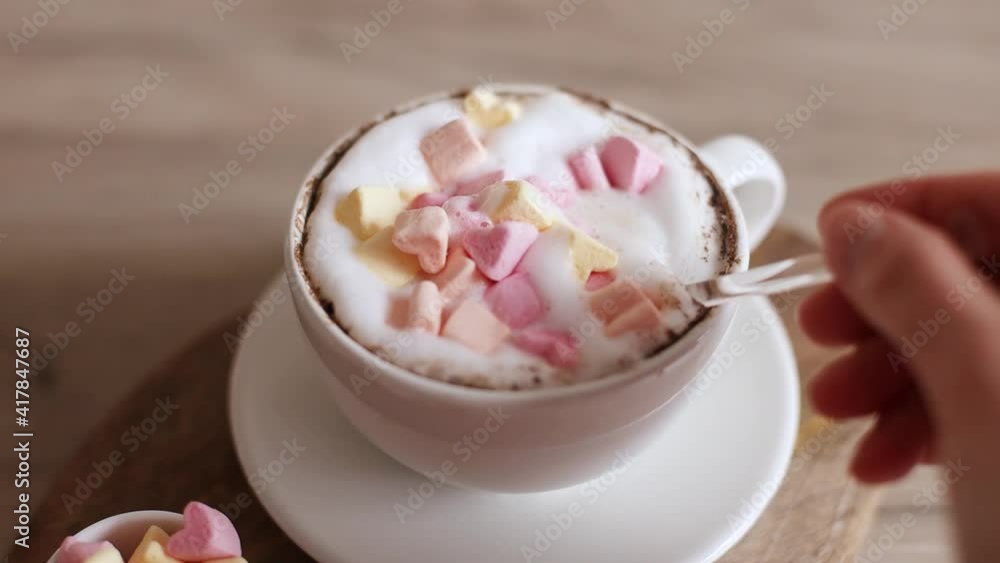 Cappuccino coffee in ceramic cup with love marshmallow candy on wooden board. Home making coffee. Tasty breakfast Cappuccino coffee in ceramic cup with love marshmallow candy on wooden board. Home making coffee. Tasty breakfast