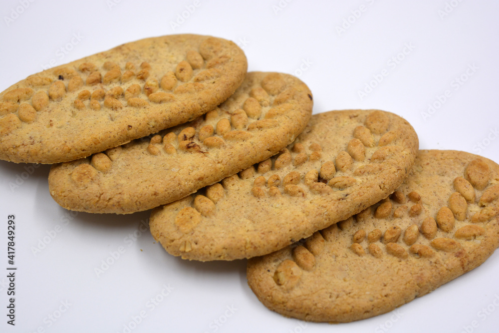 Useful satisfying slim cookies with nuts and bran located on a white background. Useful satisfying slim cookies with nuts and bran located on a white background.