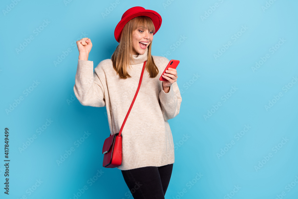 Photo of delighted attractive person fist up open mouth celebrate new comment follow isolated on blue color background Photo of delighted attractive person fist up open mouth celebrate new comment follow isolated on blue color background