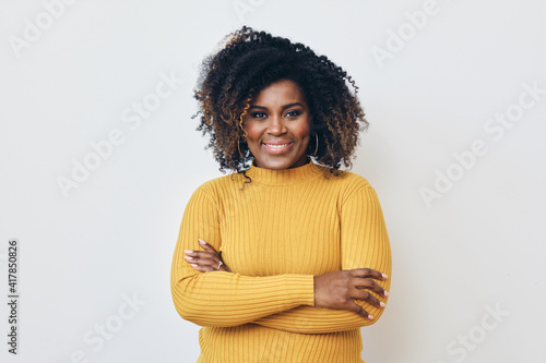 Portrait of a beautiful black woman smiling with arms crossed