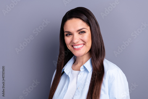 Photo of cute adorable young lady dressed blue shirt smiling isolated grey color background