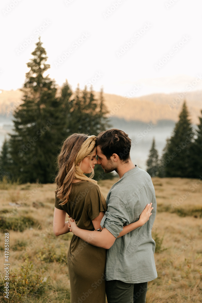 Young happy couple in love hugging smiling and having fun in the mountains Young happy couple in love hugging smiling and having fun in the mountains