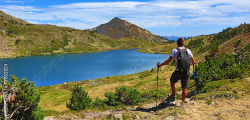 beautiful Pyrenees landscape, lake, mountain and man enjoying the view