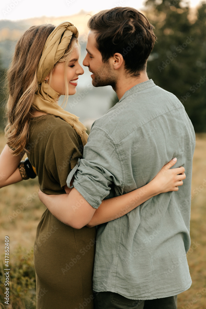 Young happy couple in love hugging smiling and having fun in the mountains Young happy couple in love hugging smiling and having fun in the mountains