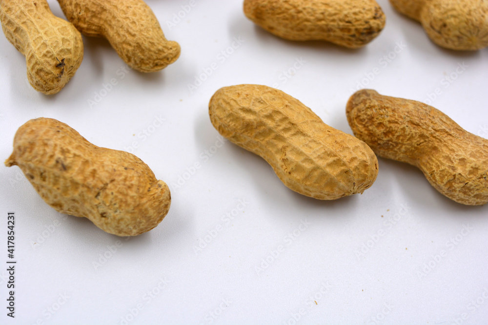 Delicious and useful nuts, brown dried peanuts in its shell, shell dismissed on a white background. Delicious and useful nuts, brown dried peanuts in its shell, shell dismissed on a white background.