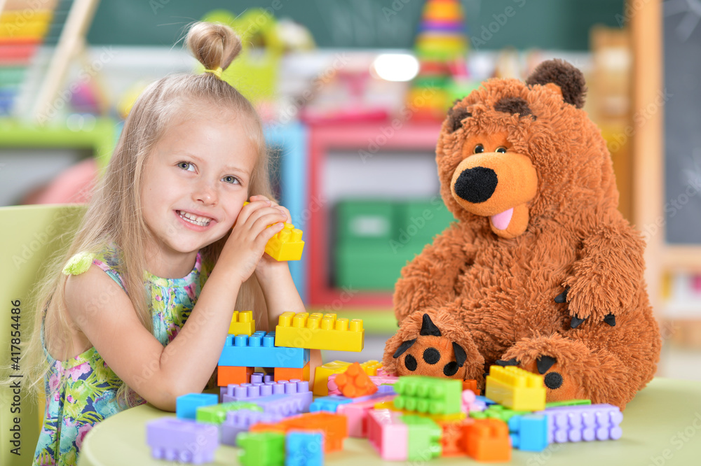 Fototapeta premium girl playing with teddy bear