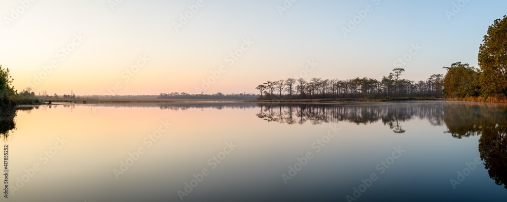Panoramic view of sunrise over the lake in nation park, Thailand.