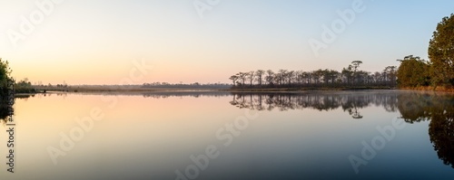 Panoramic view of sunrise over the lake in nation park, Thailand. © yotrakbutda