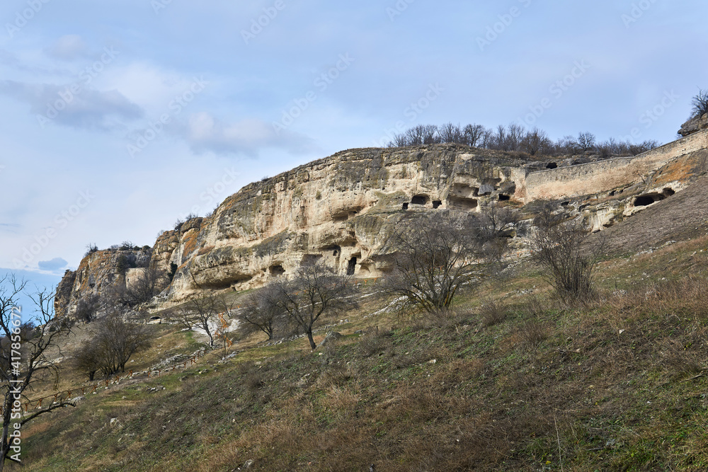 view of the ruins of an ancient cave city-fortress on a rocky slope