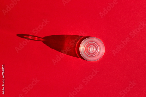 Feminine hygiene product, menstrual cup concept on bright red background with concept shadow