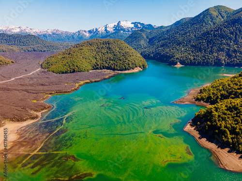 turquoise lake surrounded by mountains and forests