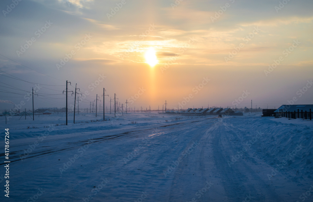 Winter morning, snowy road, morning sun.