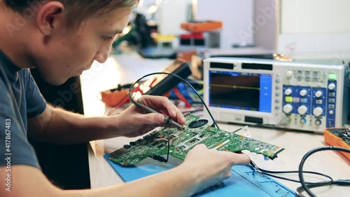 Wallpaper Mural Young specialist is measuring tension in a circuit Torontodigital.ca