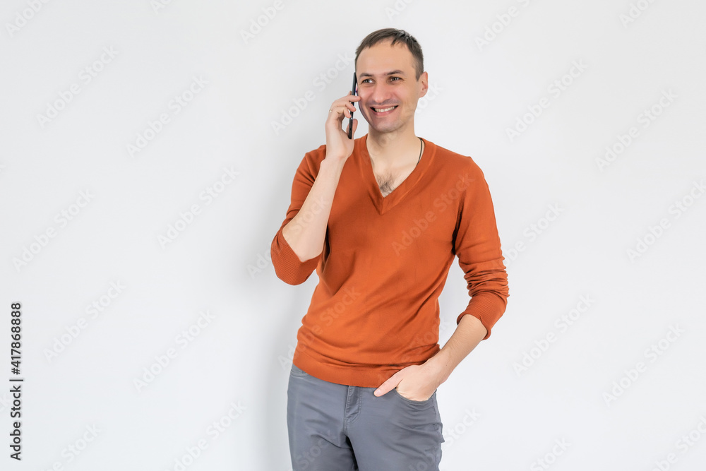 Handsome young man using his smartphone on white background Handsome young man using his smartphone on white background