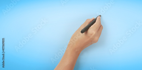 Hand is ready for drawing  black marker