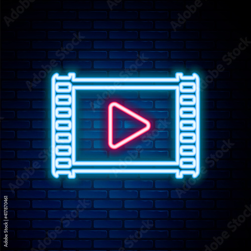 Glowing neon line Movie clapper icon isolated on brick wall background. Film clapper board. Clapperboard. Cinema production or media industry concept. Colorful outline concept. Vector.
