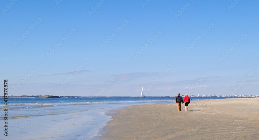 Couple walking along the beach