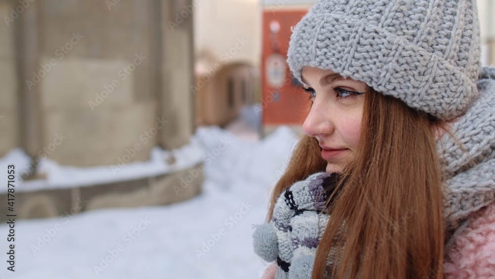 Close-up of young tourist woman warming her cold hands outdoors in winter day. Portrait of Caucasian traveler girl rubs her hands in gloves trying to keep warm in frosty weather on street in city Close-up of young tourist woman warming her cold hands outdoors in winter day. Portrait of Caucasian traveler girl rubs her hands in gloves trying to keep warm in frosty weather on street in city