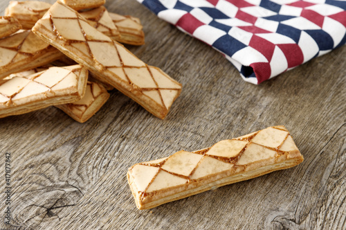 Italian puff pastry cookies with apricot glaze. Traditional Sfogliatine glassate snacks. photo