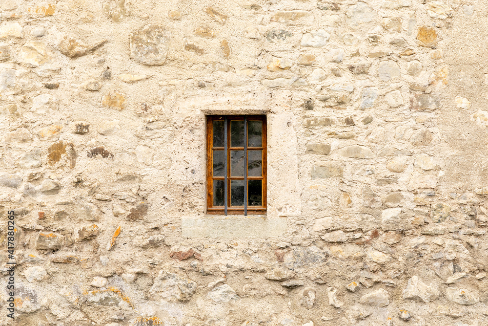 Castle window, built within a sturdy stone wall.