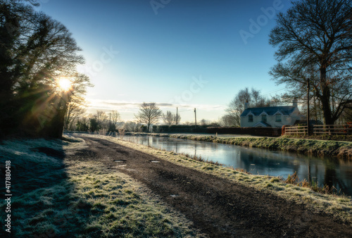 Frosty canal landscape at dawn © alan