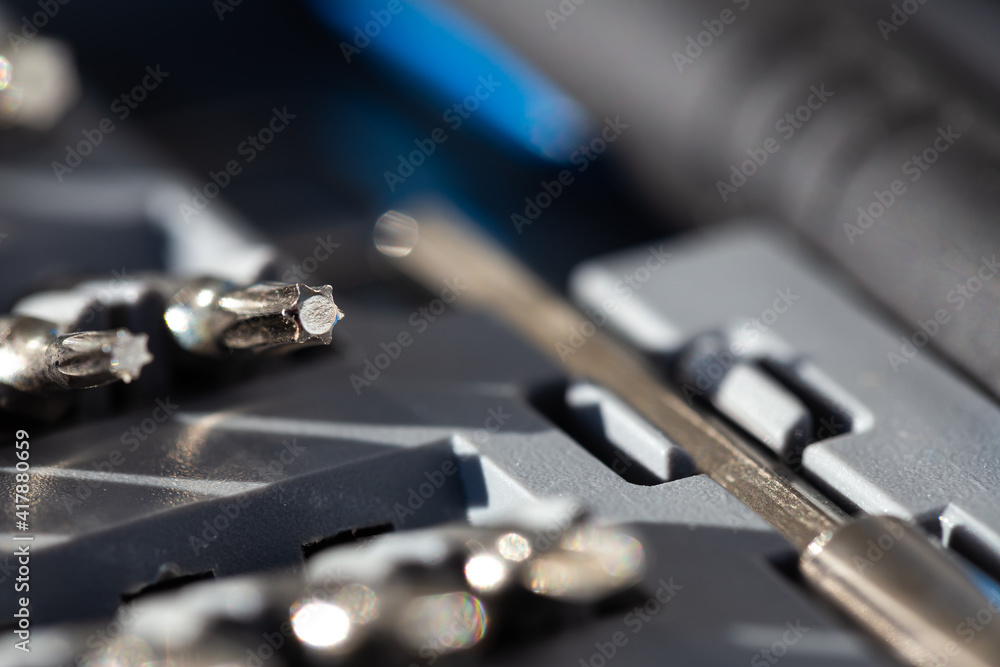 A set of precision tools and screwdrivers. Close-ups of details in natural light A set of precision tools and screwdrivers. Close-ups of details in natural light