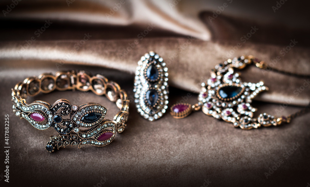 Women's jewelry on a velor background. Antique bracelet, ring and necklace. Women's jewelry on a velor background. Antique bracelet, ring and necklace.