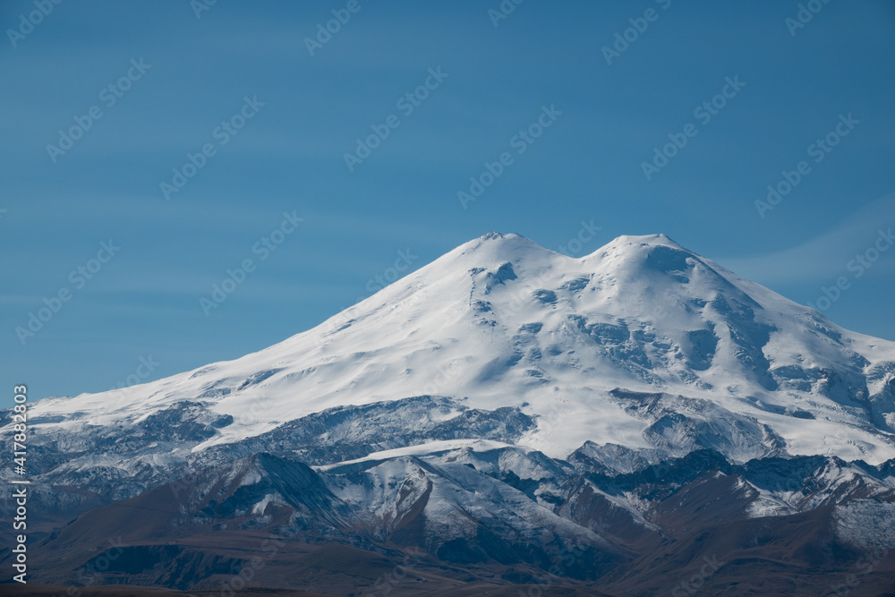 Elbrus And Green Hills At Sunny Summer Day. Elbrus Region, North Caucasus, Russia Elbrus And Green Hills At Sunny Summer Day. Elbrus Region, North Caucasus, Russia