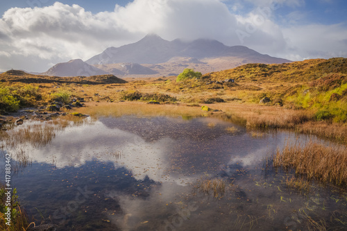 Reflection of the Black Cuillins mountain landscape in a small tarn at Sligachan on the Isle of Skye in the Scottish Highlands, Scotland.