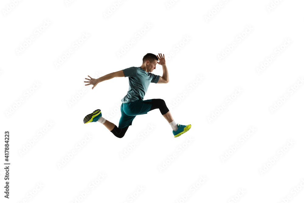 Flying. Young caucasian male model in action, motion isolated on white background with copyspace. Concept of sport, movement, energy and dynamic, healthy lifestyle. Training, practicing. Authentic.