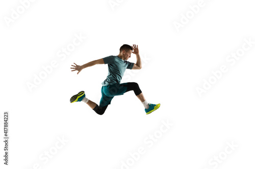 Flying. Young caucasian male model in action, motion isolated on white background with copyspace. Concept of sport, movement, energy and dynamic, healthy lifestyle. Training, practicing. Authentic.
