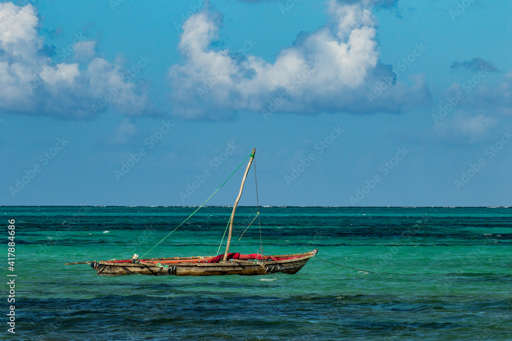 A traditional native nagalawa with sail down. The ngalawa or ungalawa is a traditional, double-outrigger canoe of the Swahili people living in Zanzibar