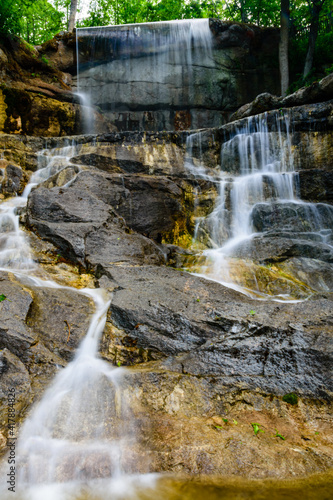 Beautiful waterfall on small river in a park