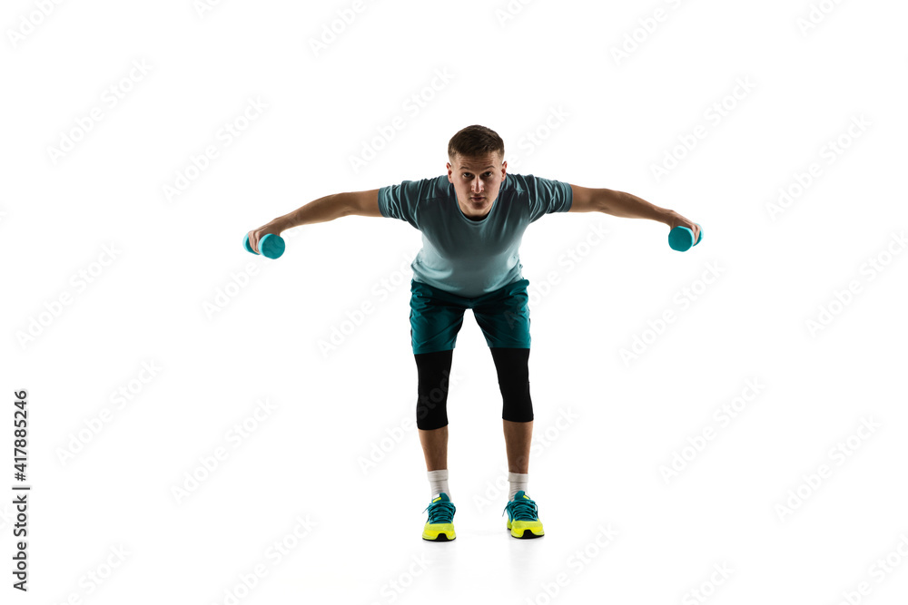 Strong. Young caucasian male model in action, motion isolated on white background with copyspace. Concept of sport, movement, energy and dynamic, healthy lifestyle. Training, practicing. Authentic.