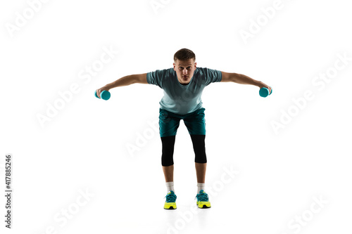 Strong. Young caucasian male model in action, motion isolated on white background with copyspace. Concept of sport, movement, energy and dynamic, healthy lifestyle. Training, practicing. Authentic.
