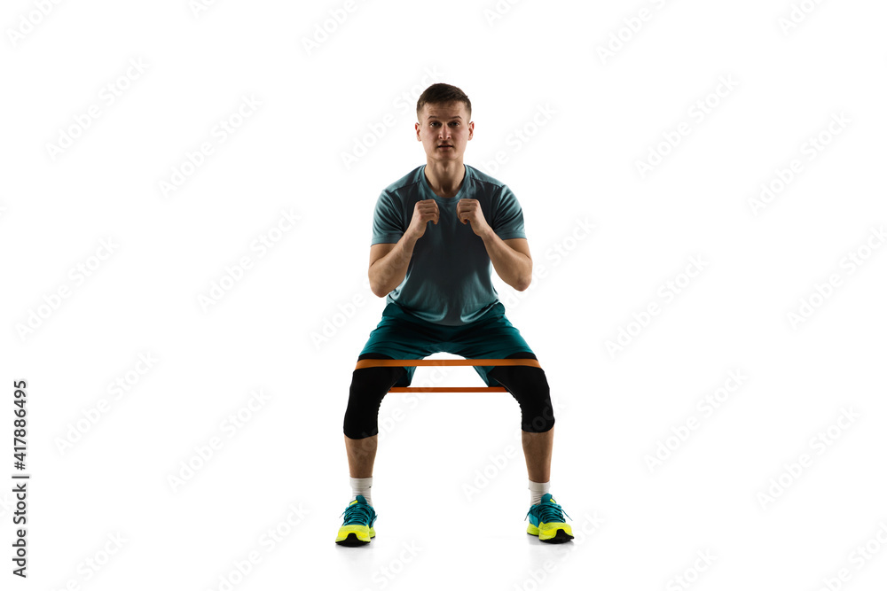 Work out. Young caucasian male model in action, motion isolated on white background with copyspace. Concept of sport, movement, energy and dynamic, healthy lifestyle. Training, practicing. Authentic.
