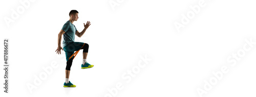 Flyer. Young caucasian male model in action, motion isolated on white background with copyspace. Concept of sport, movement, energy and dynamic, healthy lifestyle. Training, practicing. Authentic.