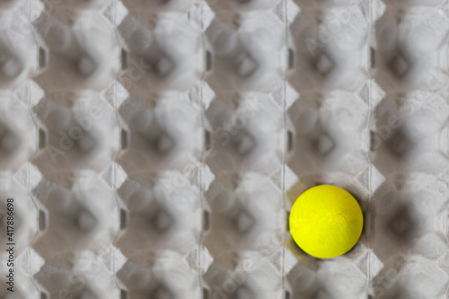 Easter yellow egg in gray tray background