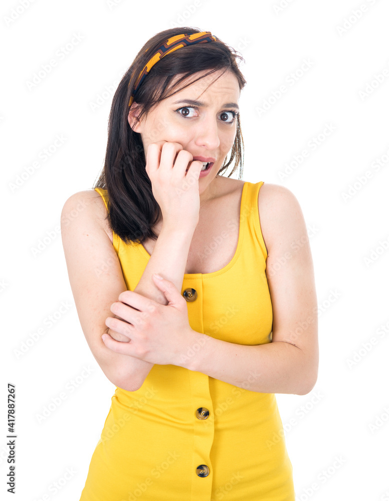 Panicked young woman biting fingernail, being terrible accident, isolated on white background. Frightened girl Panicked young woman biting fingernail, being terrible accident, isolated on white background. Frightened girl