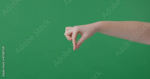 Woman hand cathching something on green screen