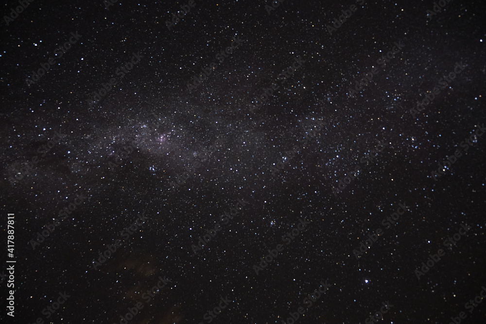 a long exposure of the dark sky with the stars