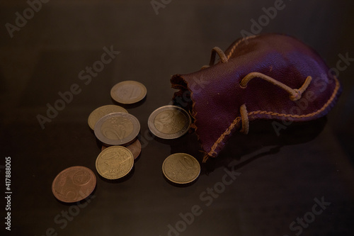 Euro coins dropped from the leather bag