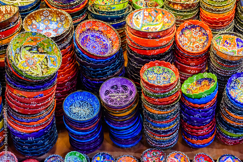 Many colorful souvenir plates for sale at the bazaar in Turkey